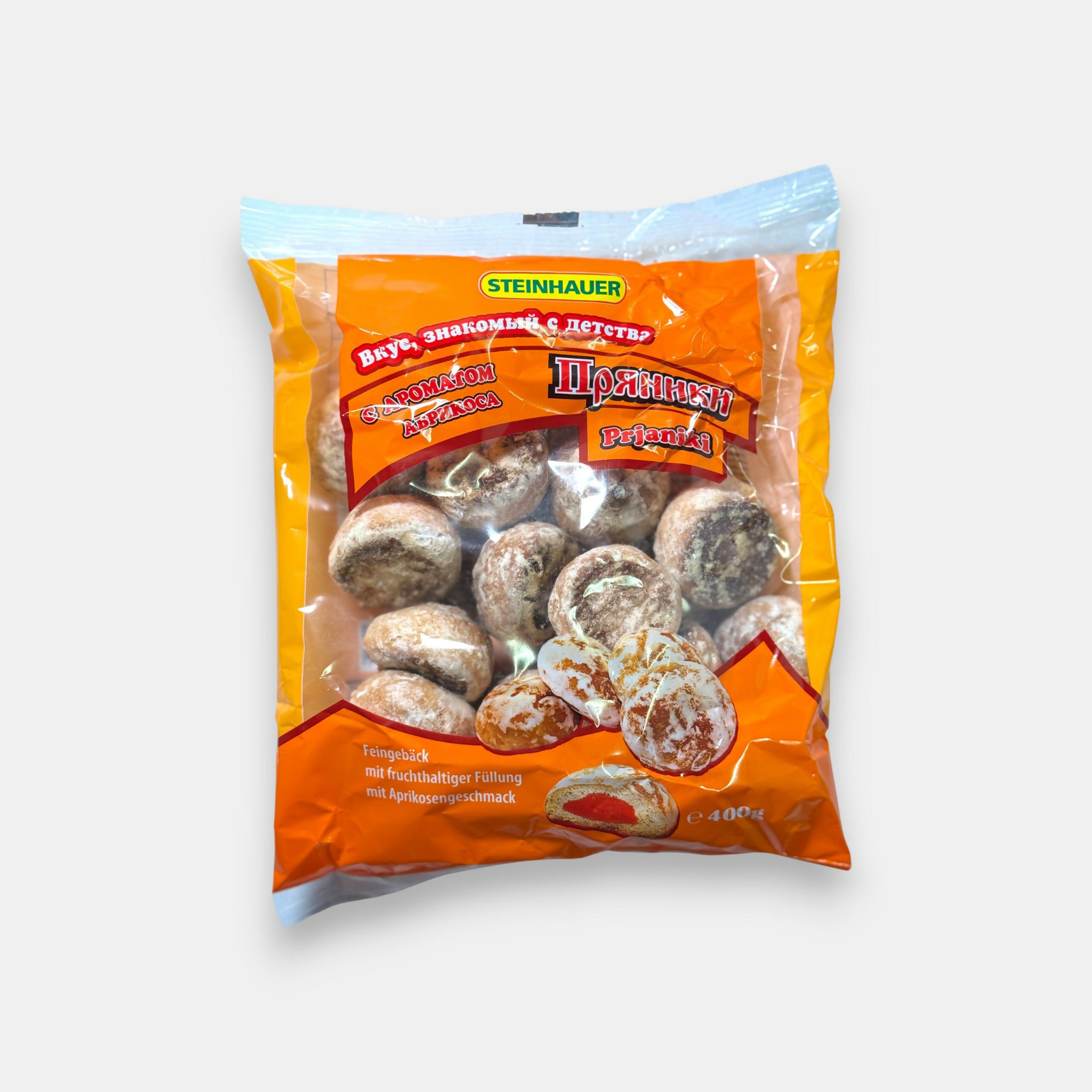 Sachet de pryaniki abricot Steinhauer, pains d’épices fourrés à la confiture d’abricot en emballage orange, disponible chez Pomo.bio, épicerie slave à Paris.