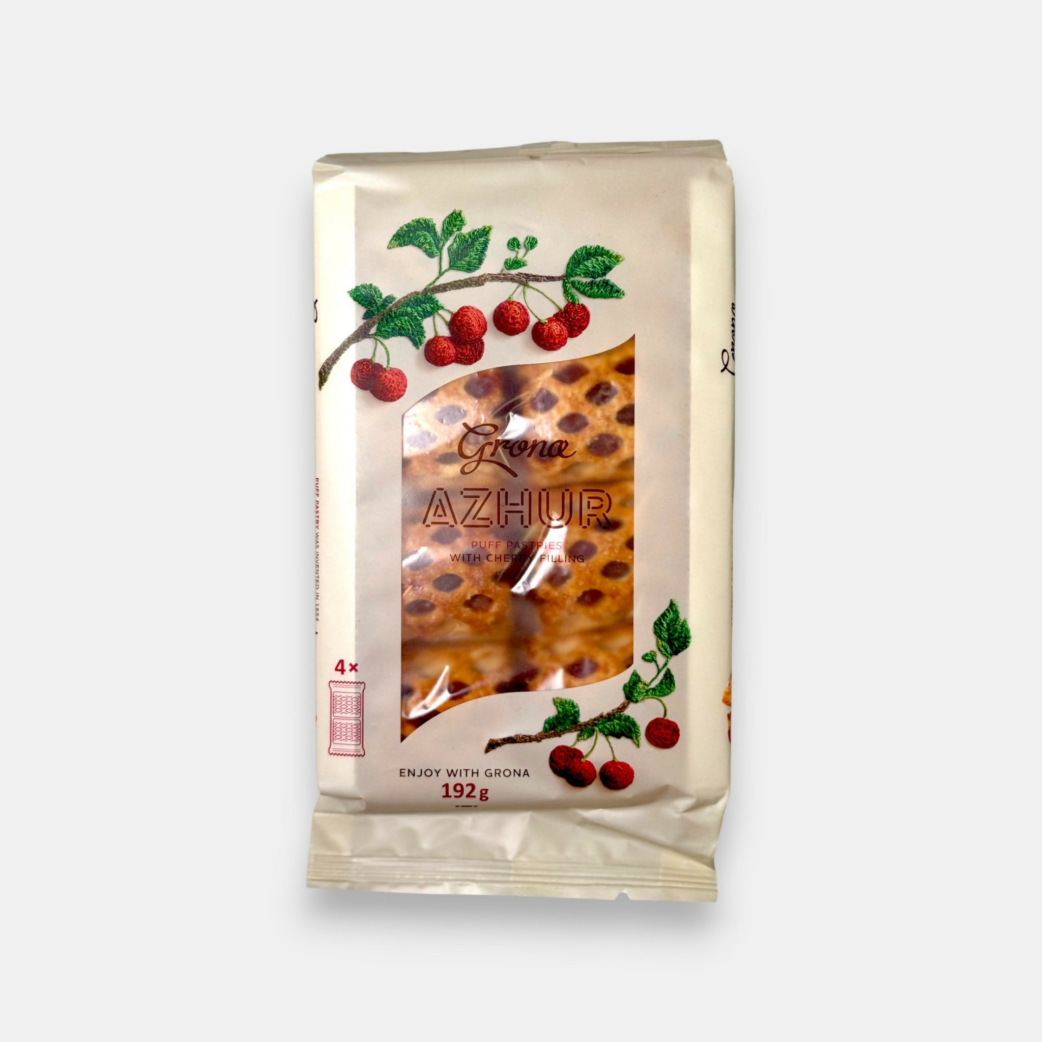 Paquet de feuilletés croustillants à la groseille noire Grona, emballage blanc décoré de baies, disponible chez Pomo.bio à Paris.