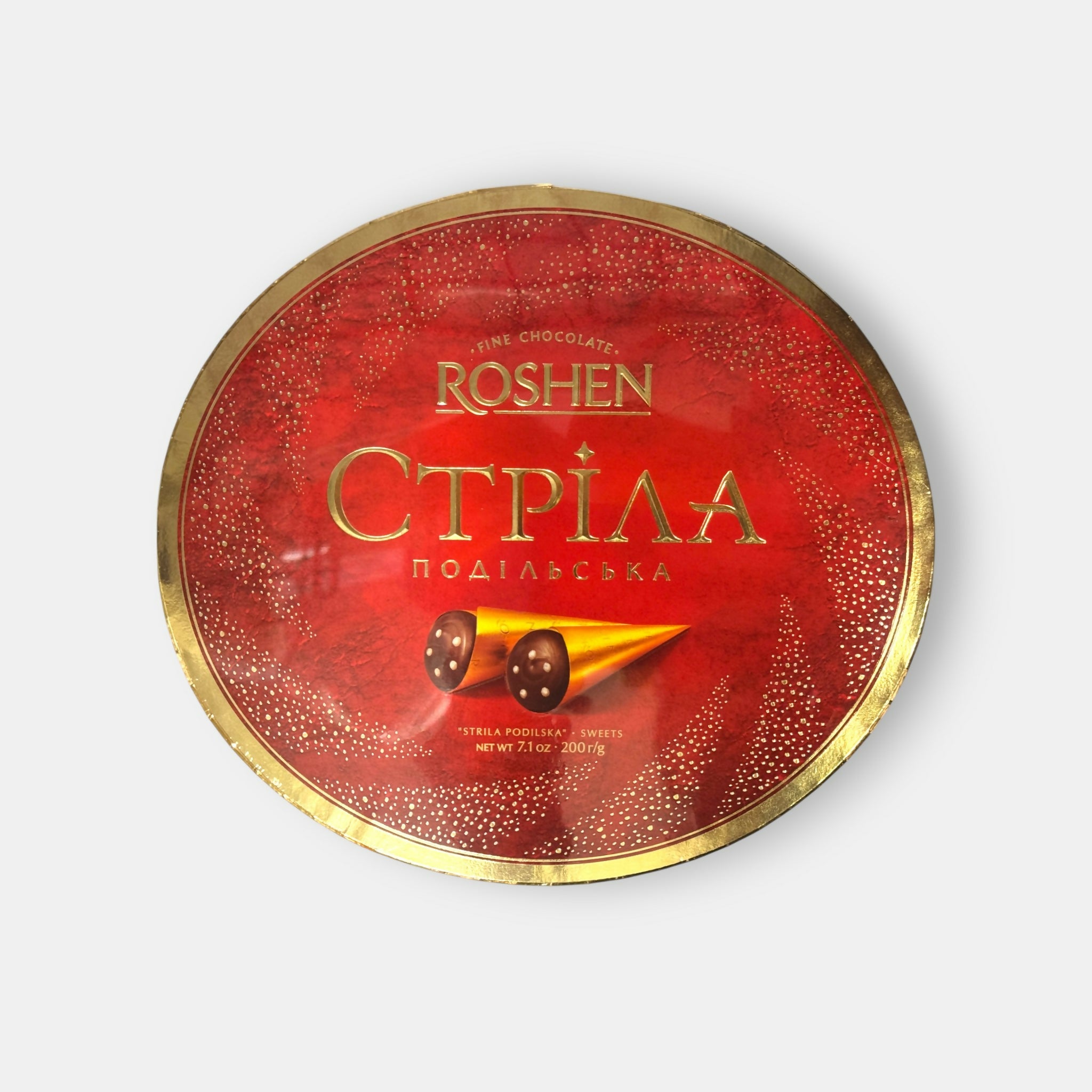 Vue de face d’une boîte ronde de bonbons Strela Podolskaya Roshen, 200 g, confiserie au caramel et cacao, épicerie slave Pomo.bio avec livraison rapide à Paris.